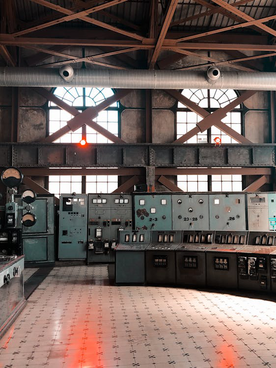 A factory showing insulated pipes along with old machinery.
