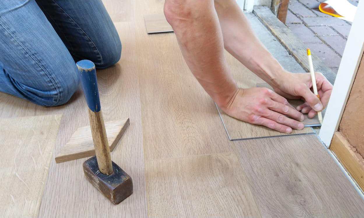 Plumber holding a pencil, preparing to mark measurements while detecting a slab leak.
