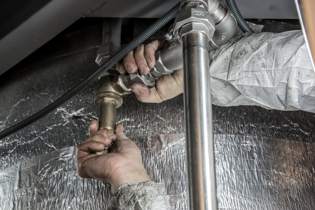 A plumber fixing pipes
